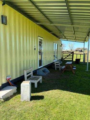 a yellow building with benches on the side of it at La Martinna 2 in Trinidad