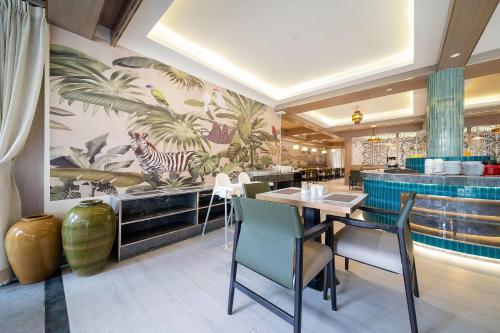 a dining room with a table and chairs at Howard Johnson by Wyndham Phuket Naiyang in Thalang