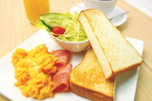 a plate of breakfast food with eggs toast and a salad at Hotel Lotus Yokohama in Yokohama