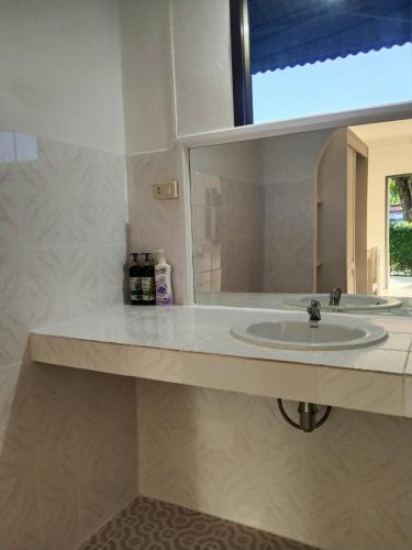 a bathroom with a sink and a mirror at Bay Beach Resort in Choeng Mon Beach