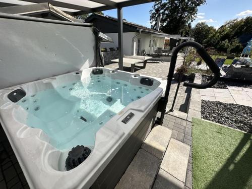a jacuzzi tub in the backyard of a house at Holiday Home Deluxe in Kleinweidelbach