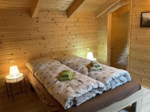 a bedroom with a bed in a wooden wall at Holiday home in Rieden with swimming pool in Rieden
