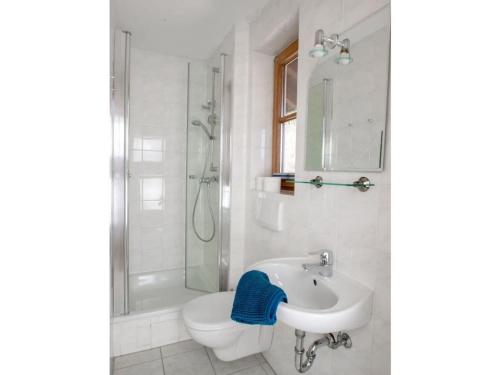 a bathroom with a sink and a toilet and a shower at Holiday apartment Waxenstein in Garmisch