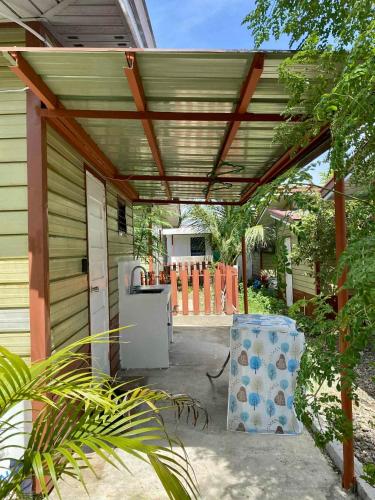 a wooden pergola over a patio of a house at Olango Island - S&E-1 Tiny Guest House Fully Furnished with Washer, Wi-Fi, Netflix & King-size Bed in Lapu Lapu City