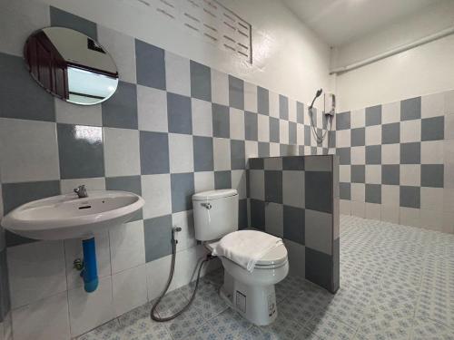 a bathroom with a sink and a toilet and a mirror at Aioun At Amphawa in Ban Bang Khan Taek (1)