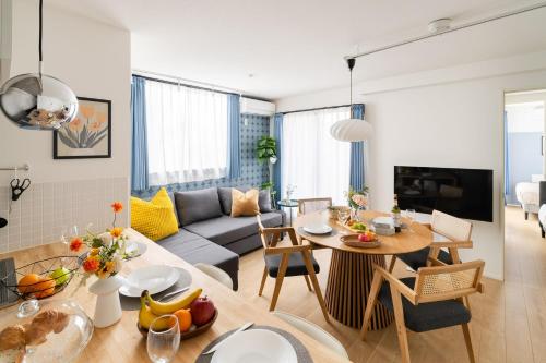 a living room with a couch and a table at ARiA STAY SHINAGAWA in Tokyo