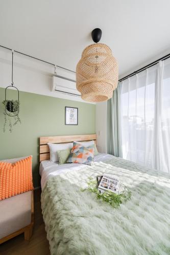 a bedroom with a large bed and a large window at ARiA STAY SHINAGAWA in Tokyo
