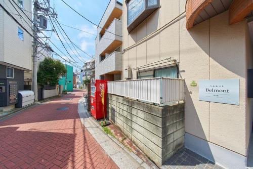 a building with a sign on the side of a street at Belmont 103 3min to Station Easy Access Ueno Asakusa Skytree Sleeps 4 in Tokyo