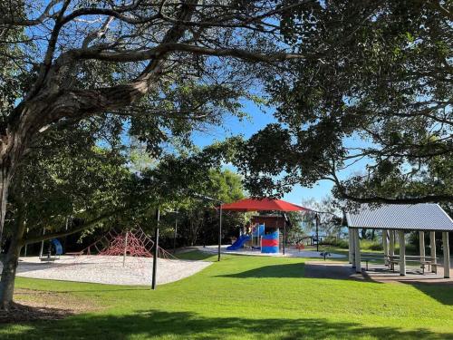 a park with a playground with a slide at Esplanade Ease - Absolute Beachfront in Hervey Bay in Point Vernon