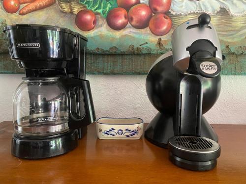 a coffee maker sitting on top of a wooden table at Casa San Pablo in Valle de Bravo