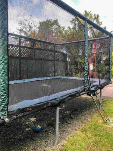 a batting cage with a net on a trampoline at The Station House Motel in Collingwood