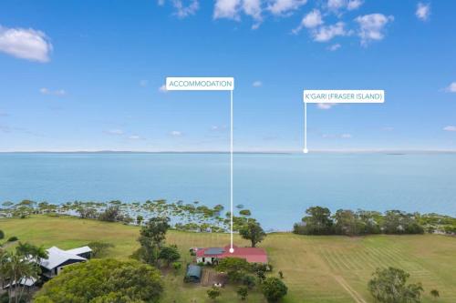 an aerial view of a house and the ocean at Beachfront Hervey Bay Homestead in River Heads