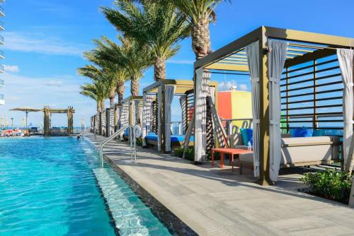 a resort with a pool and palm trees at Breathtaking Ocean-View Balcony Lyfe Resort in Beverley Beach