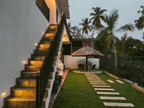 a staircase leading up to a house with grass at Finest Retreat Tangalle - Cozy Villa & Pool, Beach Nearby in Tangalle