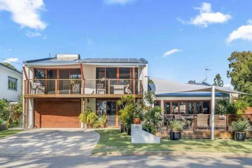 a large house with a porch and a driveway at Sunset Shores Escape in Point Vernon