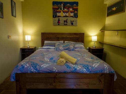 a bedroom with a bed with two pillows on it at La Casa de Zarela in Huaraz