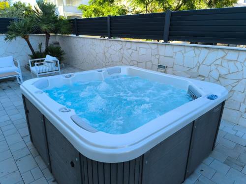 a large jacuzzi tub sitting on a patio at Villa S in Vir