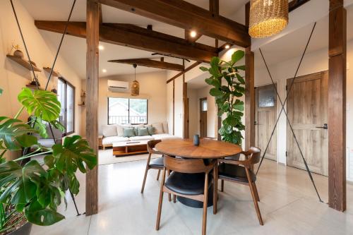 a living room with a wooden table and chairs at Oguma House in Nozawa Onsen