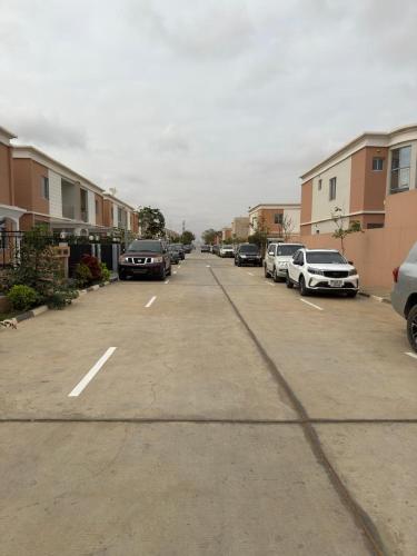 a parking lot with several cars parked in it at Cassoma Home Angola in Belas