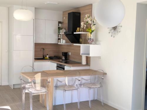 a kitchen with a wooden table and chairs at Villa S in Vir