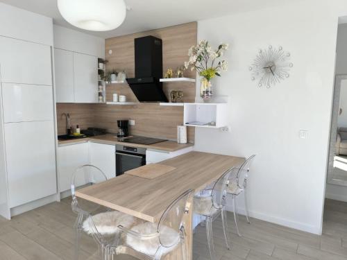a kitchen with a wooden table and chairs at Villa S in Vir