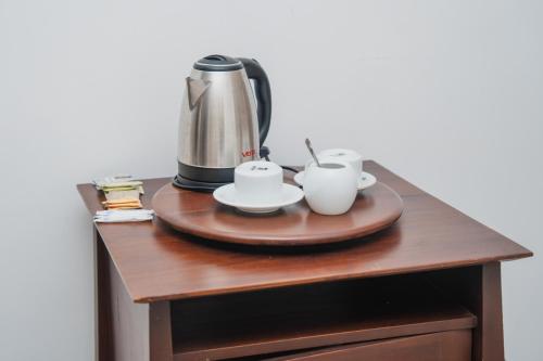 a coffee maker and two cups on a table at Clio Bolgoda in Piliyandala