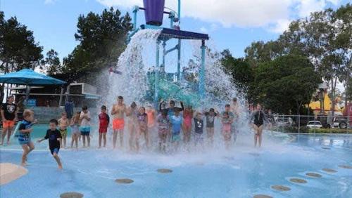 a group of children playing in a water park at Coastal Family Escape in Urangan