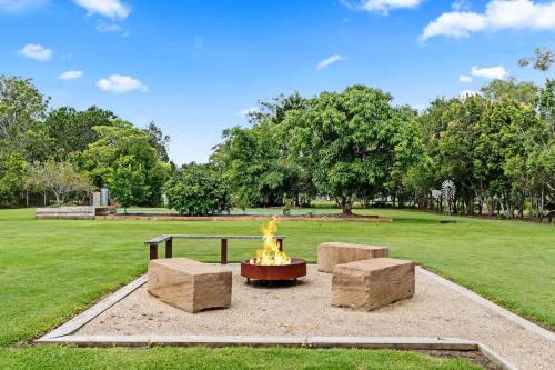 a fire pit in the middle of a park at Private Family Retreat - Pool Spa Tennis firepit in Hervey Bay