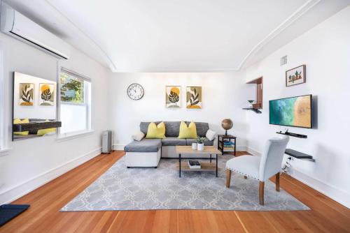 a living room with a couch and a table at Charming 2BR Roosevelt Bungalow w Quiet Yard in Seattle