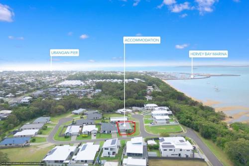 an aerial view of a suburb with houses and the ocean at Marine Bliss-4Bd Beach Access in Urangan