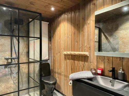 a bathroom with a sink and a glass shower at Modern Cabin With Mountain Views In Rauland in Torvetjørn