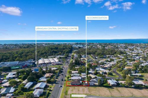 an aerial view of a city with houses and a street at Central Charm in Urangan