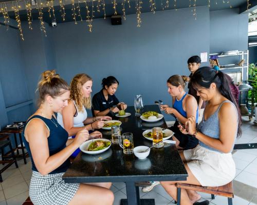 a group of women sitting at a table eating food at Onederz Phnom Penh in Phnom Penh