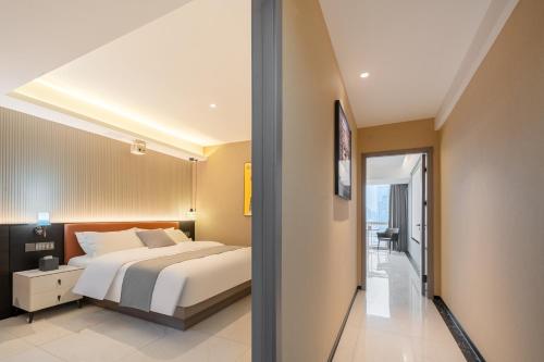 a bedroom with a large bed and a balcony at Dori1993 Hotel in Changsha