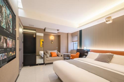 a hotel room with a bed and a living room at Dori1993 Hotel in Changsha