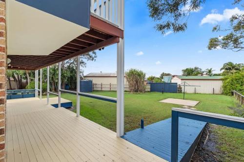 an outdoor deck with a pavilion in a yard at Whitesands Family Beachhouse in Urangan