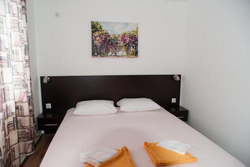 a bedroom with a bed with two towels on it at Villa Maria in Tsarevo