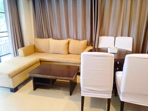 a living room with a couch and a table and chairs at Puektian Seaview Family Suite Pool in Ban Tanot Noi
