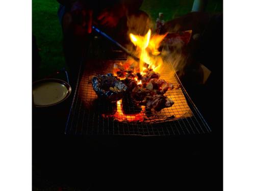 a grill with a cake on top of it at Kominka Nagomi Guest House - Vacation STAY 19240 in Miyazu