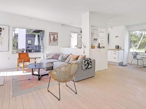 a living room with a couch and a table at 6 person holiday home in Tisvildeleje in Tisvildeleje