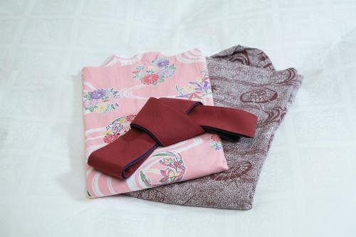 a pink bag with a bow on top of it at HOTEL & SPA J-MEX Shinjuku Kabukicho (Adult Only) in Tokyo