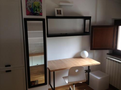 a room with a desk and a mirror and a chair at Villa Parco La Collina in Alfedena