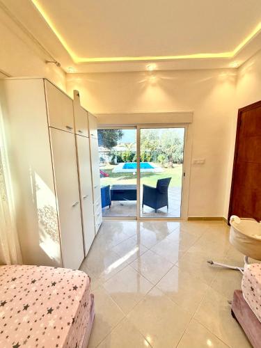a bedroom with a bed and a view of a table at Luxury Villa with Pool & Garden5km from Cabo in Tetouan