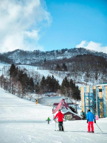 a group of people on skis in the snow at Oyado Hisaya in Kami