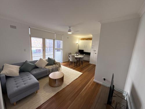 a living room with a couch and a table at Randwick Luxury 2 Bed Apt & Study Area in Sydney