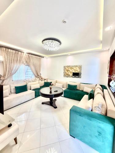 a living room with a couch and a table at Luxury Villa with Pool & Garden5km from Cabo in Tetouan