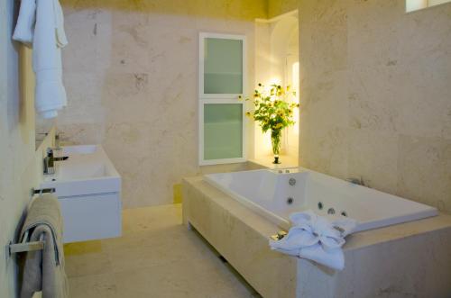 a bathroom with a large tub and a sink at Broken Hill Outback Church Stay in Broken Hill