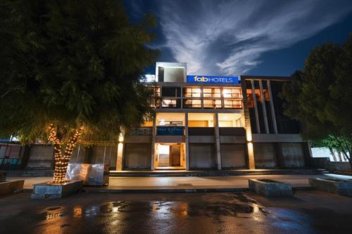 a building with a sign on the side of it at FabHotel Relax - opp Hotel Leela in Gandhinagar