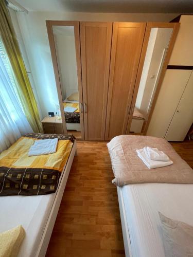 a bedroom with two beds and a mirror at MAD Ferienwohnungen 2 in Dortmund