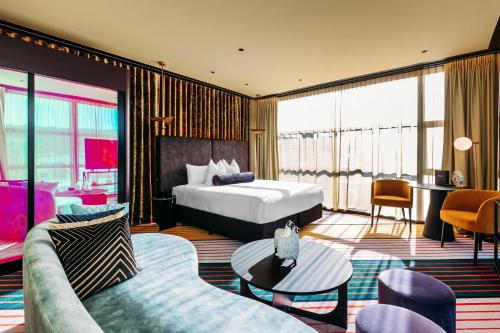 a hotel room with a bed and a couch at Naumi Hotel Wellington in Wellington